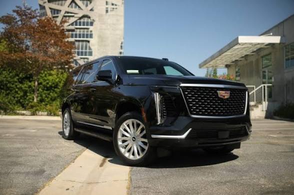 Black Cadillac Escalade luxury SUV at modern location